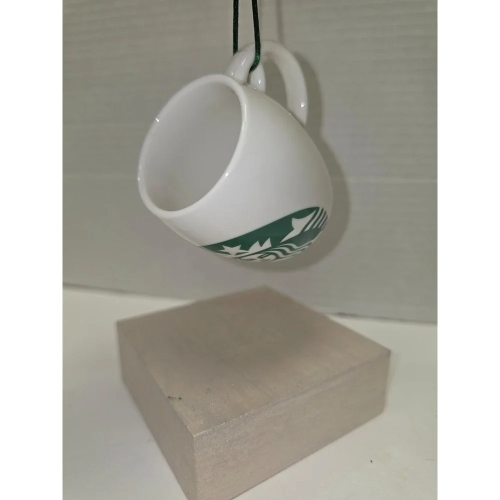 white‎ ceramic Starbucks ornament featuring a green siren logo